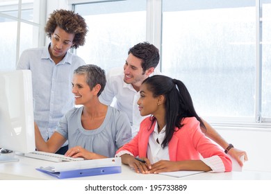 Worker showing colleagues her progress in the office - Shutterstock ID 195733889