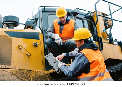 Worker Sitting On Heavy Excavation Machinery In Mining Operation