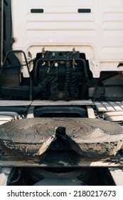 A Worker Smearing Trailer Fifth Wheel Coupling With Lubricant Oil. Semi-truck Mechanical Maintenance 