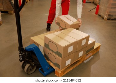 Worker sorting cardboard boxes in warehouse, closeup. Logistics concept