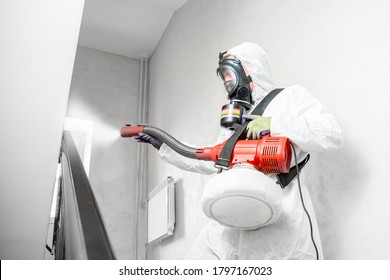 Worker Specialist In White Hazmat Suits Cleaning Disinfecting Cells Coronavirus Epidemic, Clear Virus Home Pandemic.