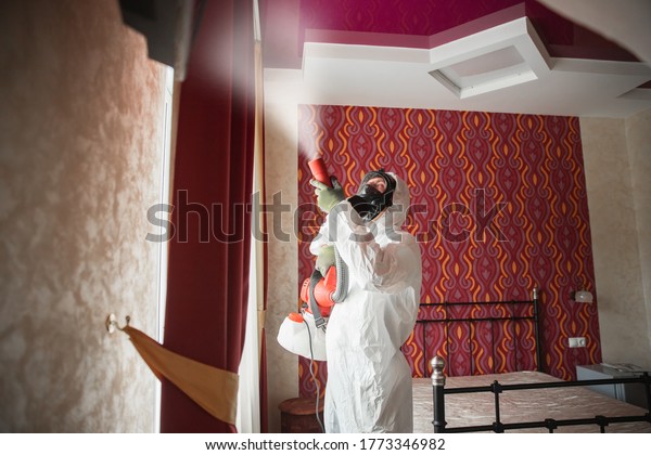 Worker\
specialist in white hazmat suits cleaning disinfecting cells\
coronavirus epidemic, clear virus home\
pandemic.