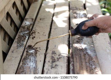 Worker Spraying Insecticide Chemical For Termite Pest Control On Wooden Deck