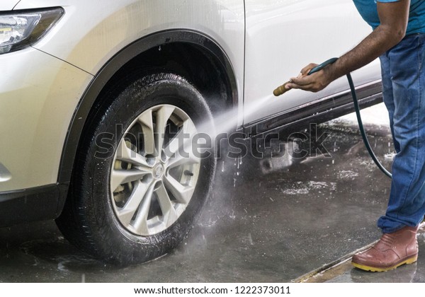 Worker Spraying Water Onto Car Wash Stock Photo Edit Now 1222373011