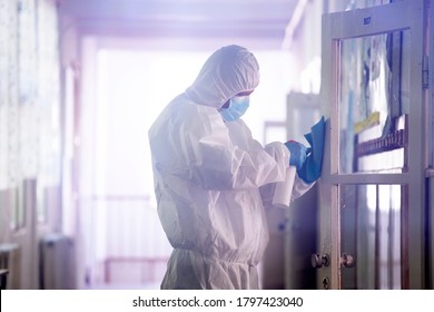 Worker sprays disinfectant as part of preventive measures against the spread of the COVID-19, the novel coronavirus in schools. Preparing for the new school season. - Shutterstock ID 1797423040