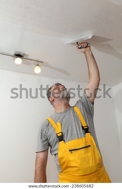 Worker Spreading Plaster Ceiling Trowel Repairing Stock Photo