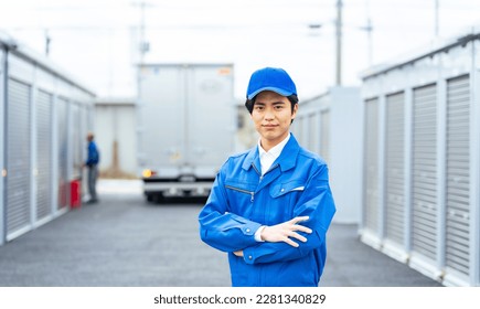 A worker standing in front of a container warehouse.