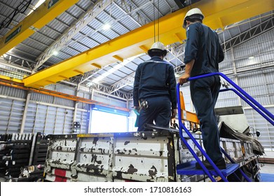 Worker standing on the blue ladder with foreman on the truck. - Powered by Shutterstock