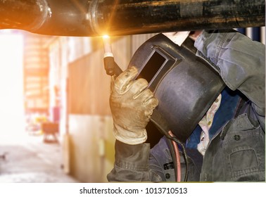 worker standing welding steel with protective mask in factory in business steel big - Shutterstock ID 1013710513