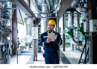 Worker supervisor in district heating plant doing quality control and inspection of pipes and valves. - Powered by Shutterstock