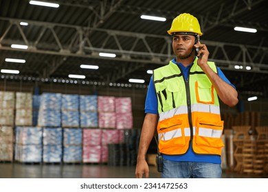 worker talking on smartphone to customer in the warehouse factory - Powered by Shutterstock