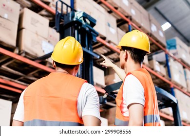 Worker team taking inventory in logistics warehouse - Powered by Shutterstock