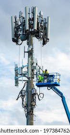 Worker Technicians Doing Installation Work On A Mobile Telecommunication Cell Tower For Wireless Internet Connection In Australia