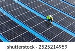 Worker Technicians are working to construct solar panels system on roof. Installing solar photovoltaic panel system. Men technicians walking on roof structure to check photovoltaic solar modules.