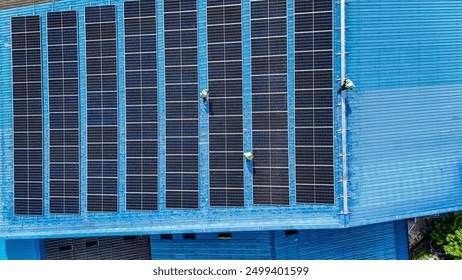 Worker Technicians are working to construct solar panels system on roof. Installing solar photovoltaic panel system. Men technicians walking on roof structure to check photovoltaic solar modules.