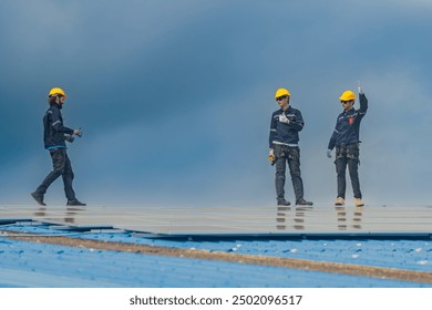 Worker Technicians are working to construct solar panels system on roof. Installing solar photovoltaic panel system. Men technicians walking on roof structure to check photovoltaic solar modules.