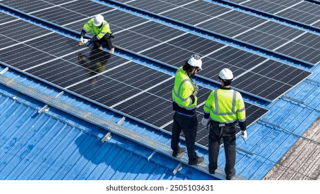 Worker Technicians are working to construct solar panels system on roof. Installing solar photovoltaic panel system. Men technicians walking on roof structure to check photovoltaic solar modules.