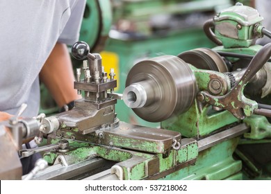 Worker Turning Part By Manual Lathe Machine.