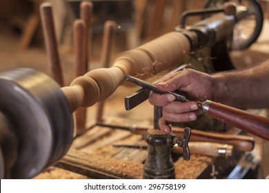 Worker Turning Wood On A Lathe