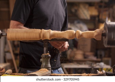 Worker Turning Wood On A Lathe