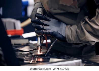 Worker use weld metal welding machine in workshop, blue sparks. - Powered by Shutterstock