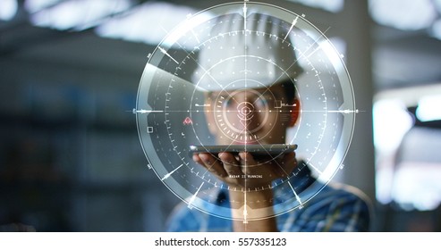 A worker uses a future technology platform to verify the design in holography and augmented virtual reality. Concept: future technology, multimedia technology, futuristic engineering.