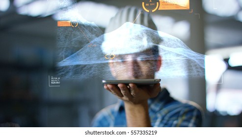 A worker uses a future technology platform to verify the design in holography and augmented virtual reality. Concept: future technology, multimedia technology, futuristic engineering.