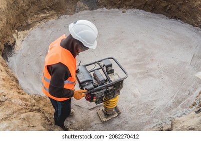 Worker Uses A Portable Vibration Rammer At Construction Of A Power Transmission Substation