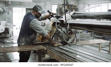 Worker Uses Saw Machine For Cutting Marble Stone Piece