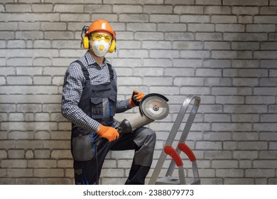 Worker is using angle grinder. Construction concept. Builder wearing in personal protective equipments.
