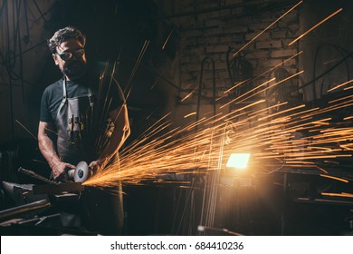 Worker Using Angle Grinder In Factory And Throwing Sparks