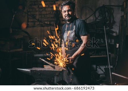 Worker Using Angle Grinder in Factory and throwing sparks in camera