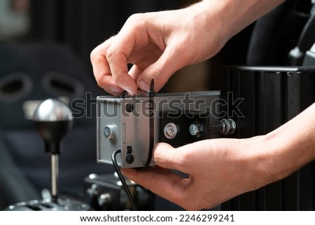 worker using black plastic clamp tie to tight cables