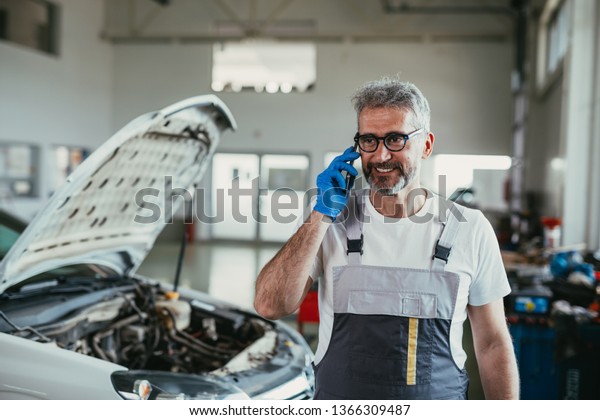 worker using cellphone in\
car service