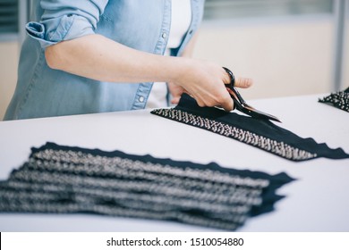 worker using a cutter - a large machine for cutting fabrics- in a Turkish textile factory, he wears a chain glove