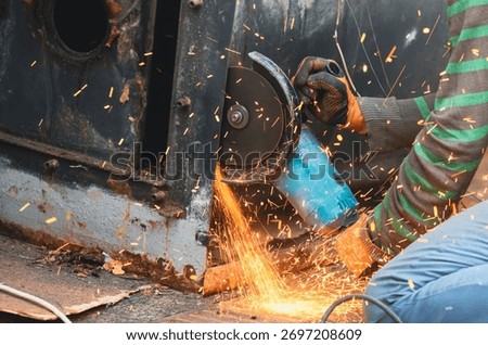 Worker using a cutting disc to cut metal