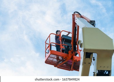 Worker Using His Phone On An Elevated Platform