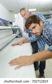 Worker Using A Large Format Ink Jet Printer