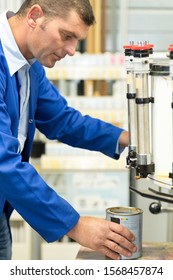 Worker Using Paint Mixing Machine