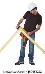 Worker Using A Right Angle Ruler To Measure An Angle