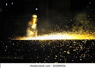 worker using torch cutter