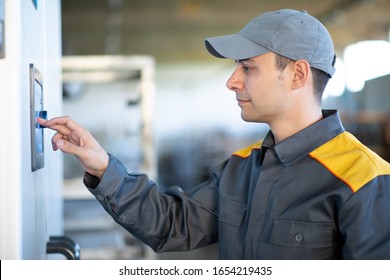 Worker using a touchscreen in an industrial factory