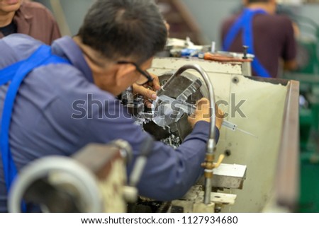 Worker Using a Vernier Caliper. Accurate Measurement. Mechanical technician measuring with caliper in workshop for work piece on lathe machine

