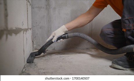 Worker Vacuuming Concrete Floors. Preparing The Floor For Waterproofing. Construction Cleaning With An Industrial Vacuum Cleaner. Dust Removal With A Vacuum Cleaner