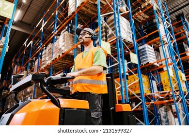 A worker with voice picking headset driving orders for shipping on forklift at storage. - Powered by Shutterstock