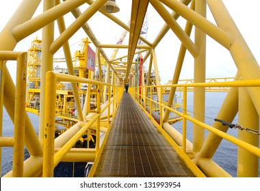 The Worker Is Walking Cross The Pathway Bridge Of Offshore Oil Rig