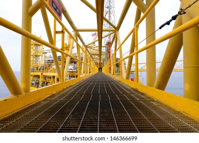 The Worker Is Walking Cross The Pathway Bridge Of Offshore Oil Rig