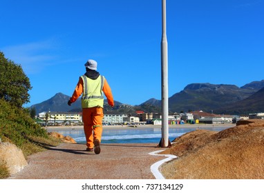 Worker walking to work on  the beach 