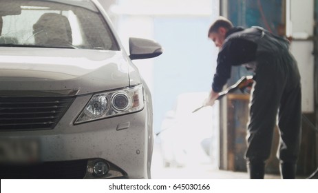 Worker Washes The Car In Workshop - Manual Labour