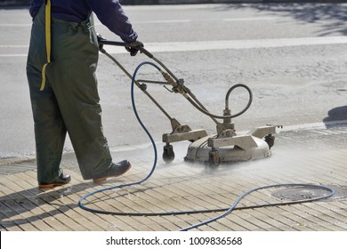worker washes the pavement